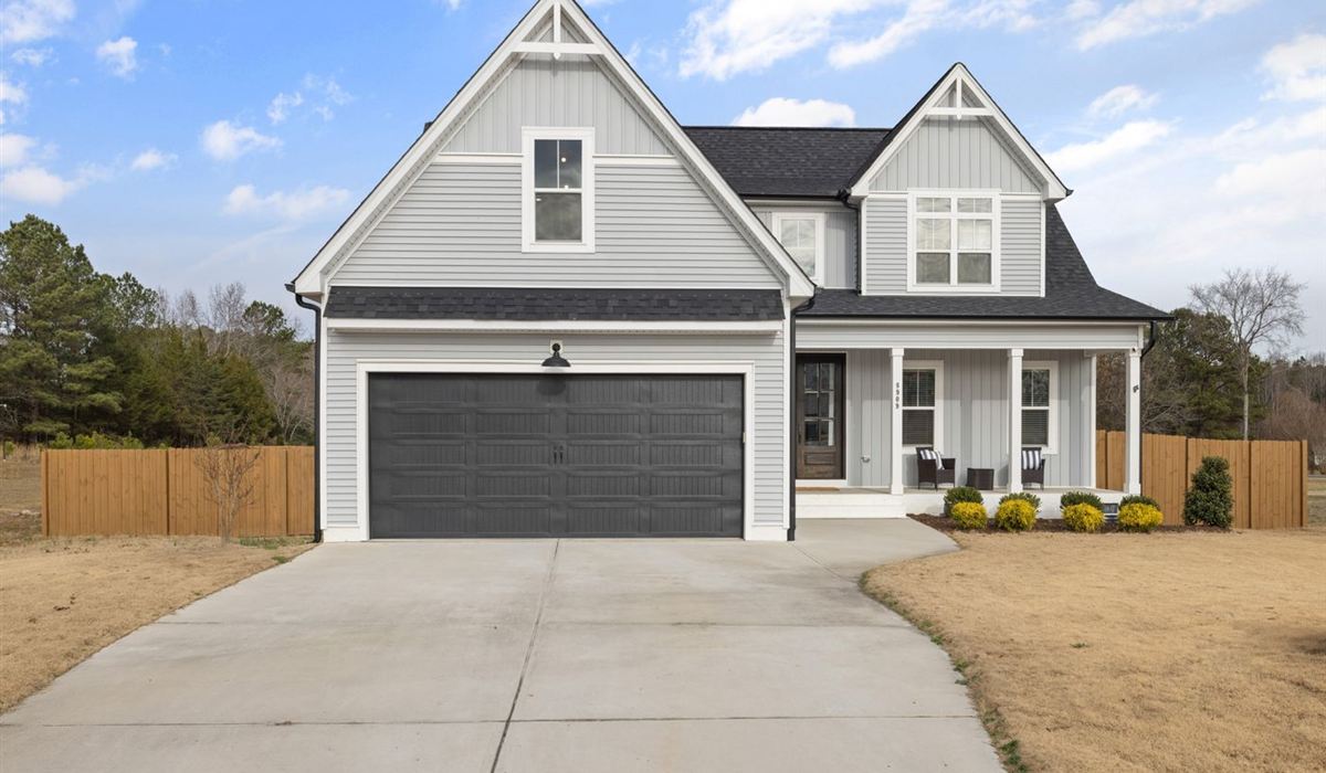 Two-storey Ajax home with a double garage door and clear driveway