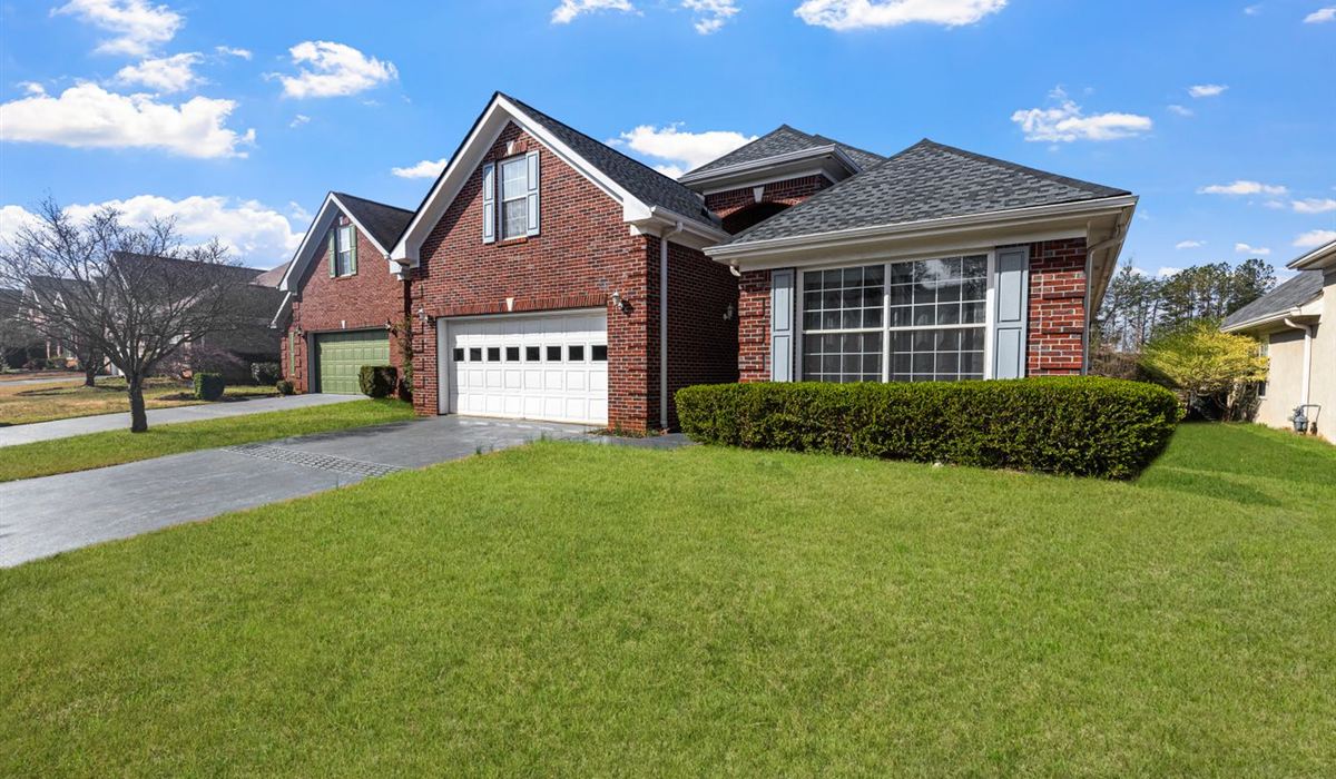 Brick Brampton home with a wide double garage door