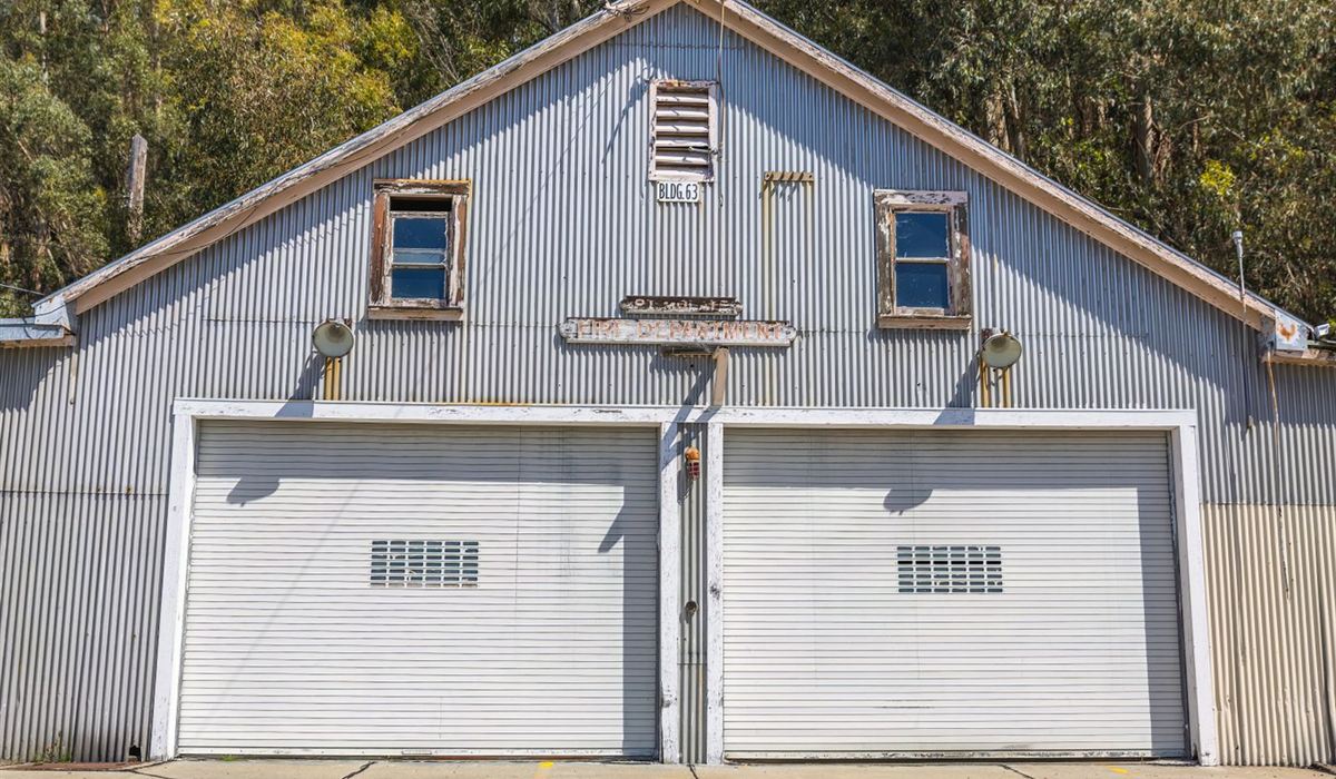Older metal garage with weathered double doors, typical of Oshawa's original housing stock
