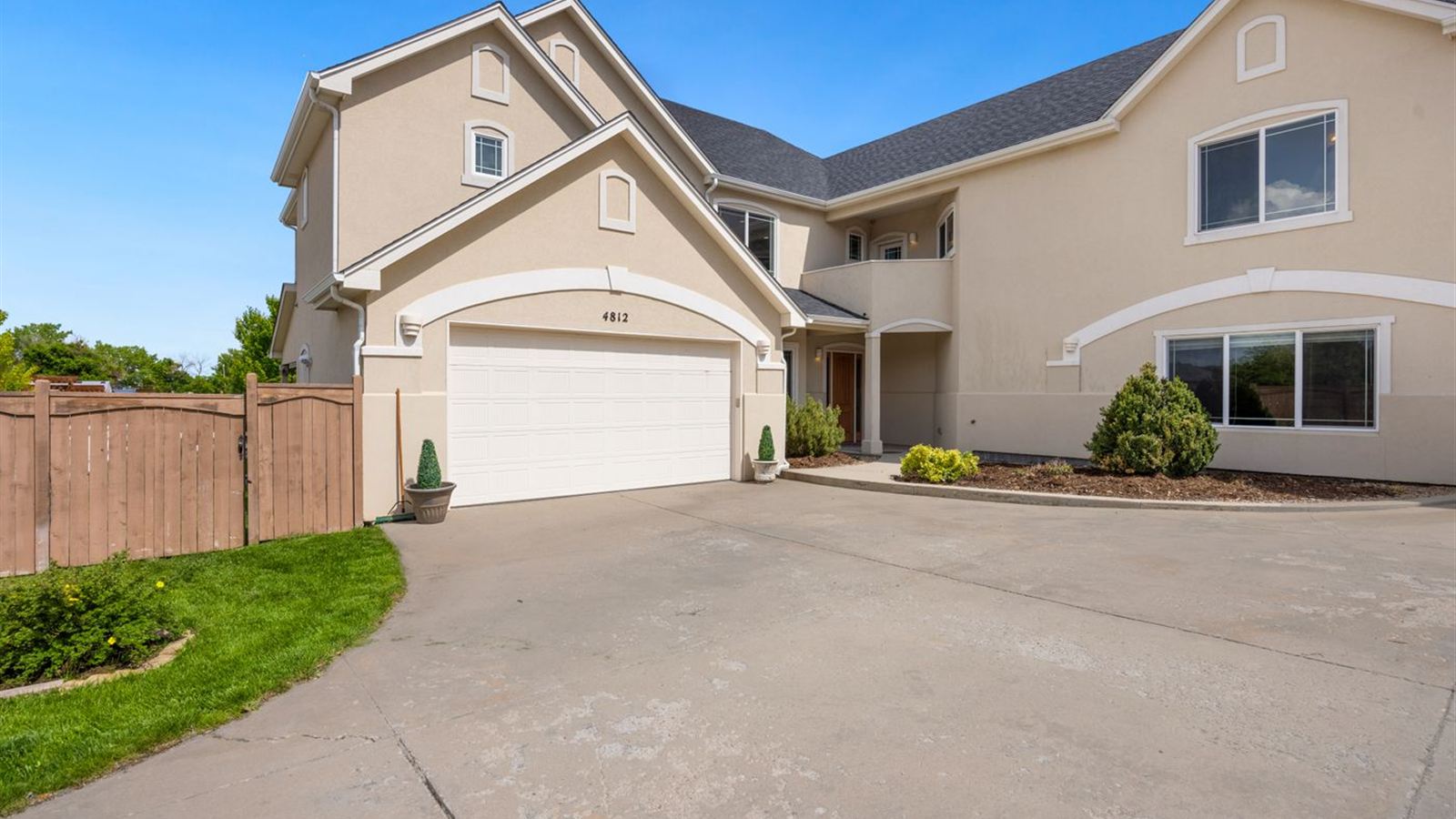 Townhouses with double garage doors on a wide shared driveway