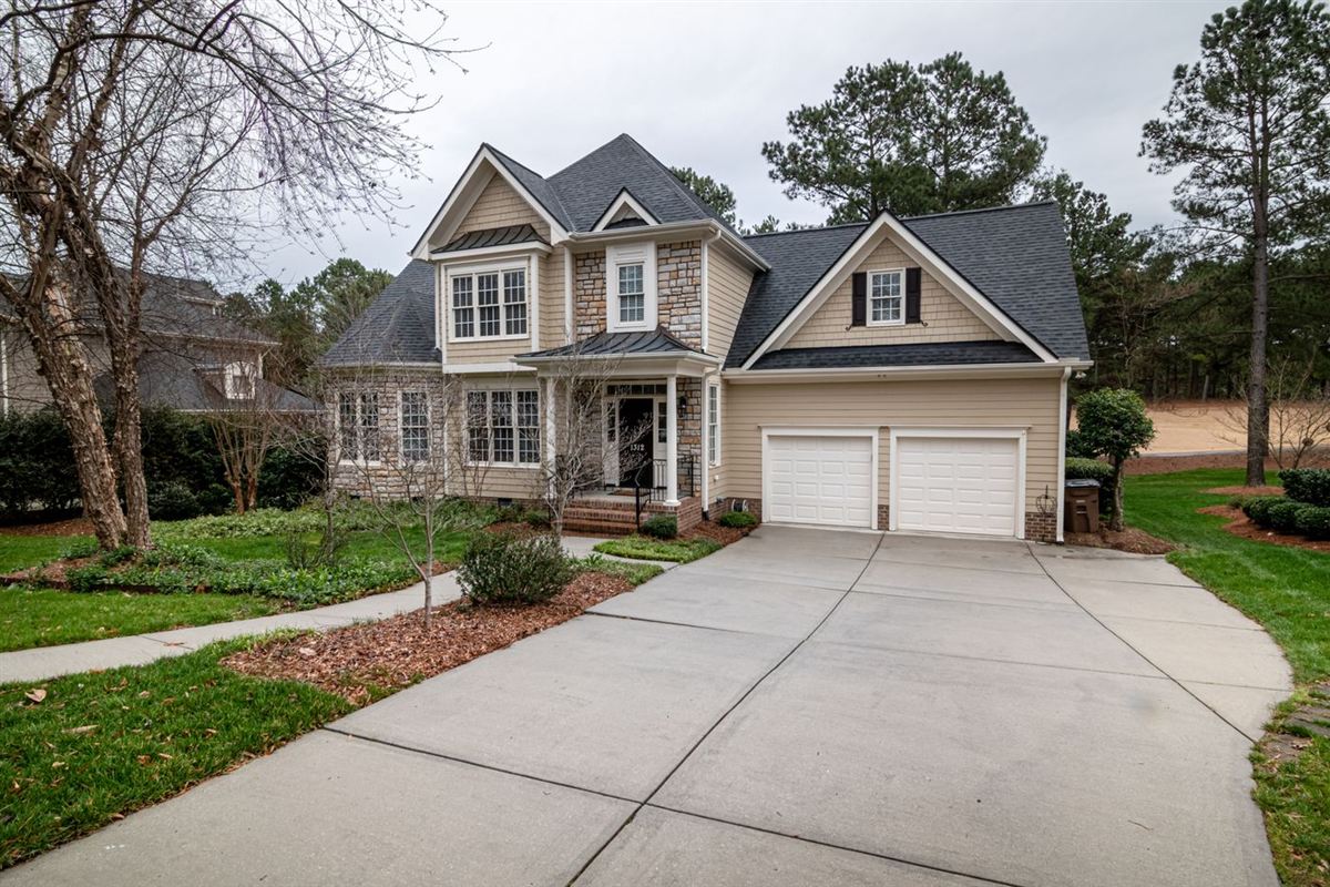 Two-car garage on a suburban home with a clear concrete driveway