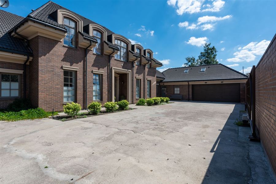 Traditional raised-panel garage doors on a brick home
