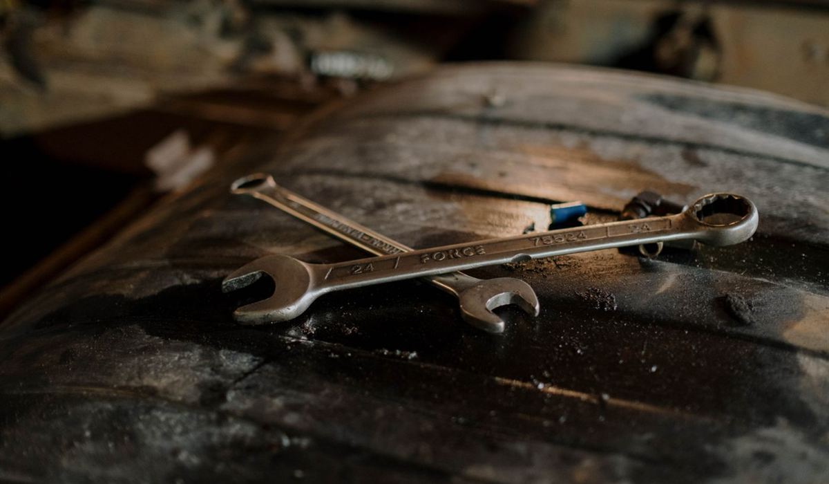 Worn spanners resting on a weathered workbench