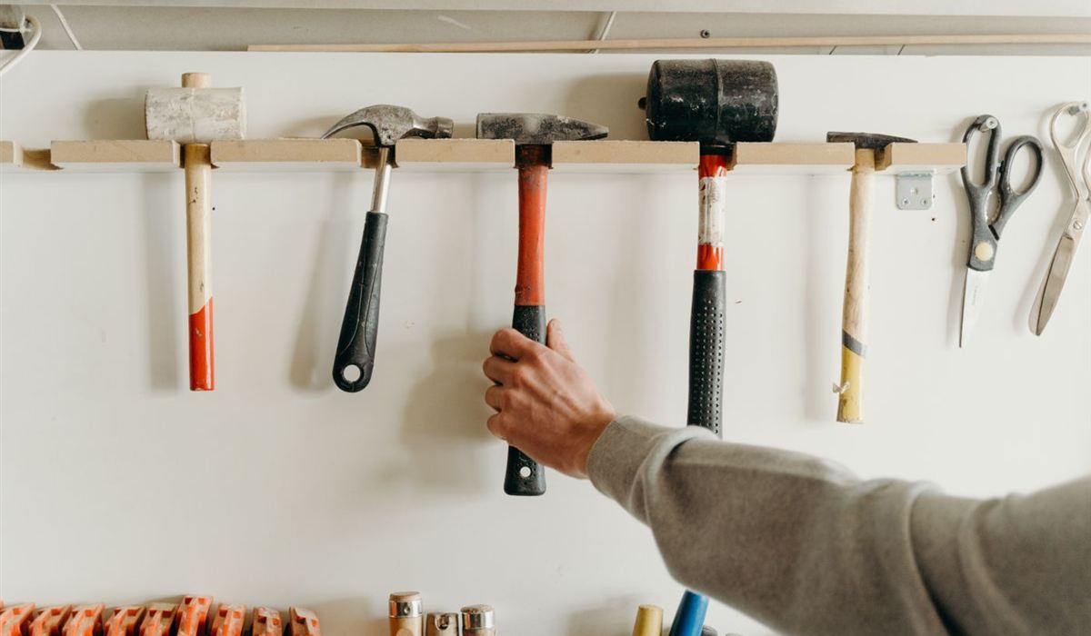 Tidy garage wall with hand tools hung on a rail