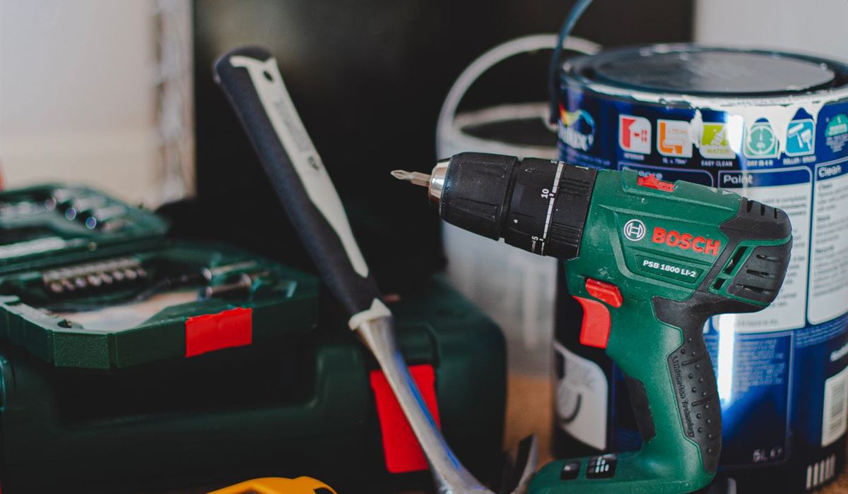 Cordless drill and hand tools ready for a maintenance visit